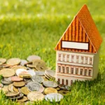 A wooden house besides a lot of coins