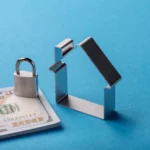 A lock on top of a bill beside a house.