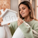 Woman holding a house