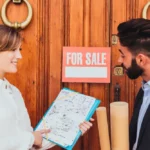 A woman selling a man a house