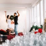 a man and a woman standing on a bed