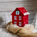 a red house sitting on top of a pile of snow