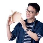 Man holding a wooden house