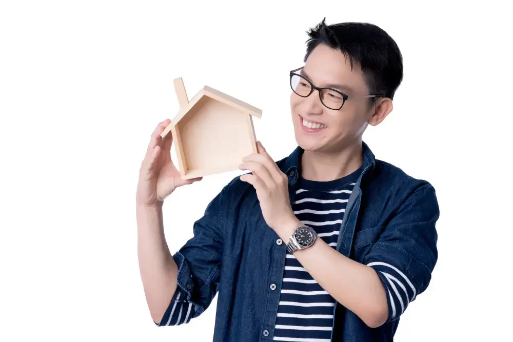 Man holding a wooden house