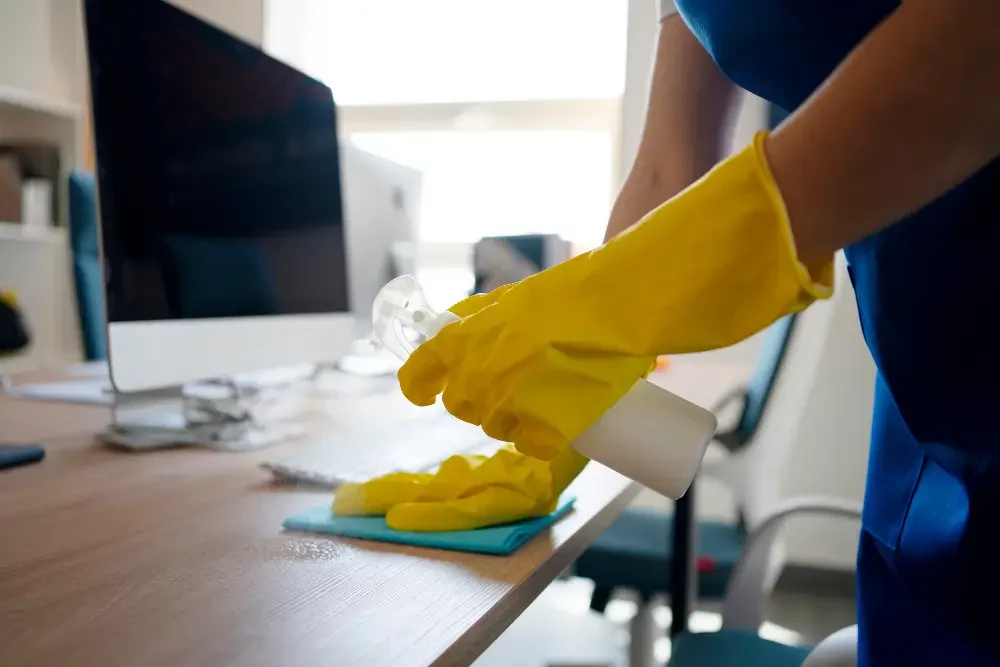 a person cleaning a desk