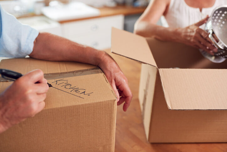 Close-Up-Of-Senior-Couple-Downsizing-In-Retirement-Boxes-Ready-For-Move-Into-New-Home-downsize-your-house-tigard-beaverton-hillsoboro-oregon