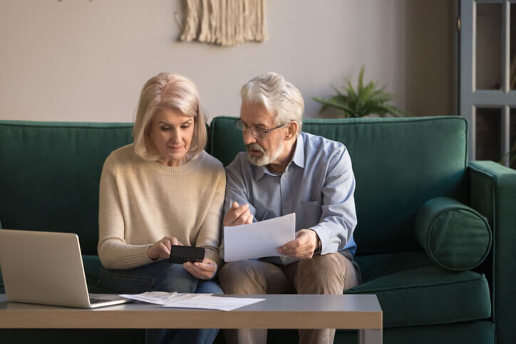 Serious-mature-couple-calculating-bills,-checking-home-listing-fees-newberg-mcminnville-dundee-bridgetown-home-buyers
