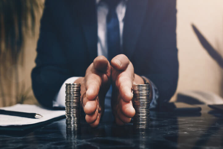 Businessman-separates-stack-coins-divorce-and-selling-your-house-portland-vancouver-bridgetown-home-buyers