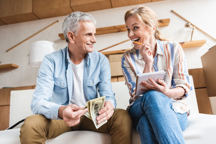 happy-elderly-couple-counting-money-and-laughing-while-moving-home-selling-process-tigard-beaverton-hillsboro-bridgetown-home-buyers