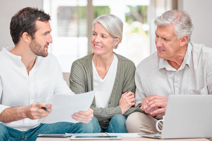 Cropped-shot-of-a-handsome-young-male-real-estate-buyer-helping-a-senior-couple-with-their-finances-in-their-portland-oregon-home