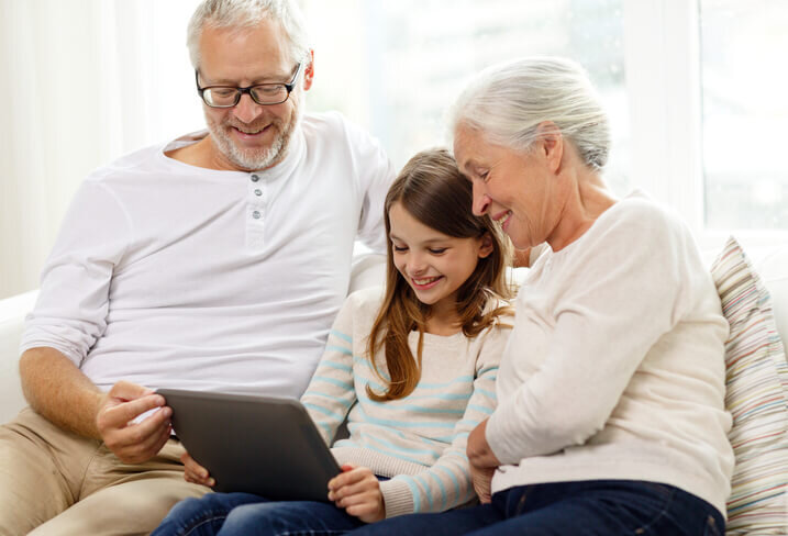 smiling-family-with-tablet-pc-at-home-looking-to-sell-a-house-portland-or