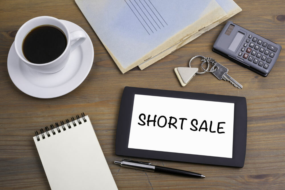 Short Sale text on tablet device on a wooden table