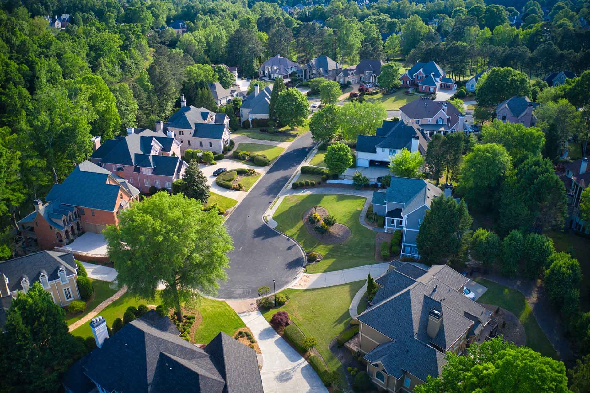 luxurious suburban neighborhood amid forest aerial view