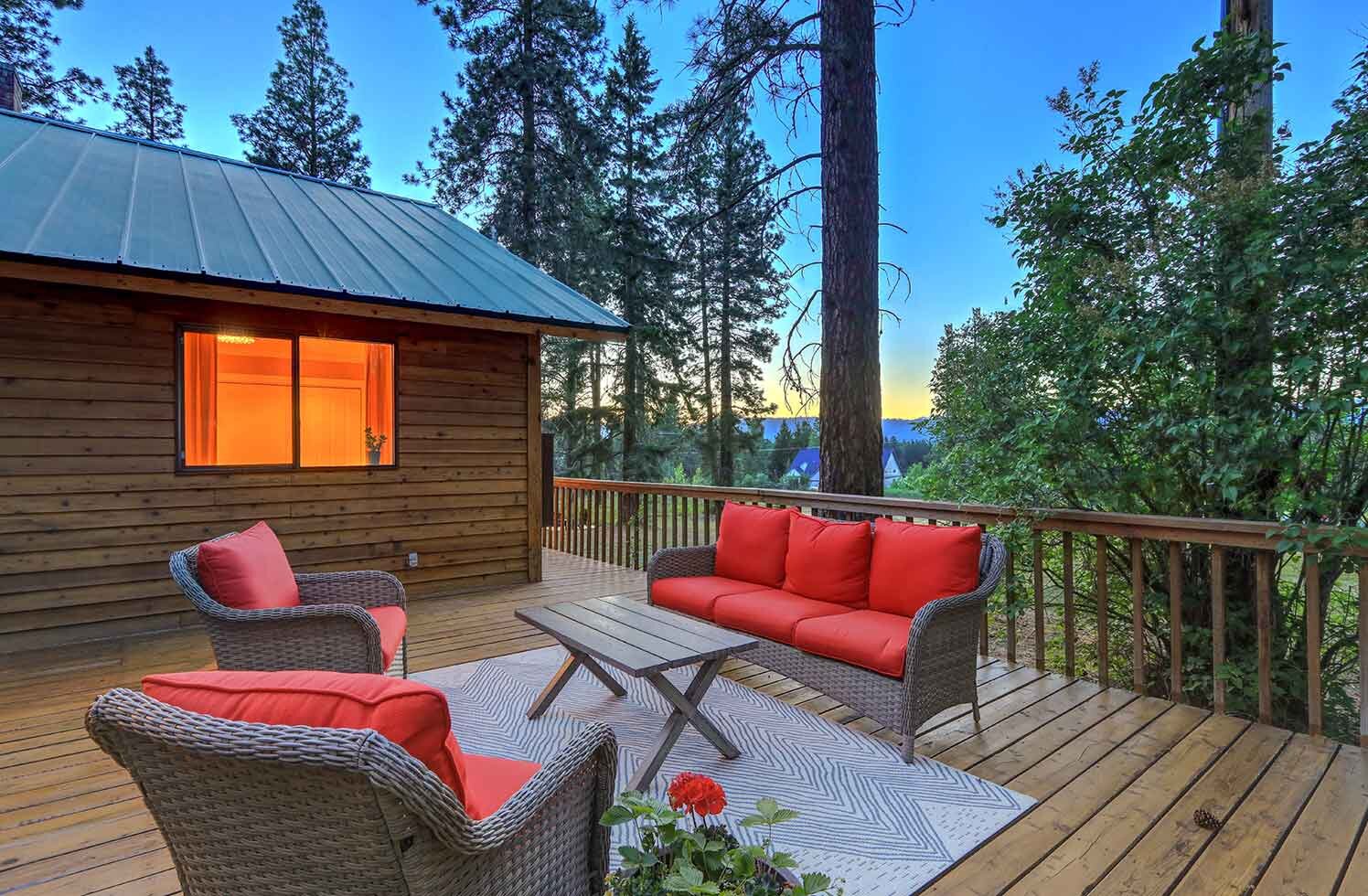 single family home back patio furniture overlooking a forest