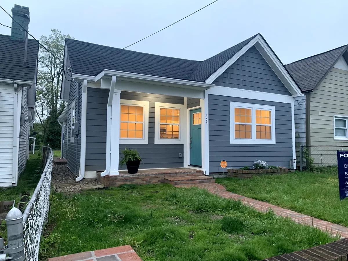 After: Renovated exterior of MLK Blvd home at dusk, Lexington KY