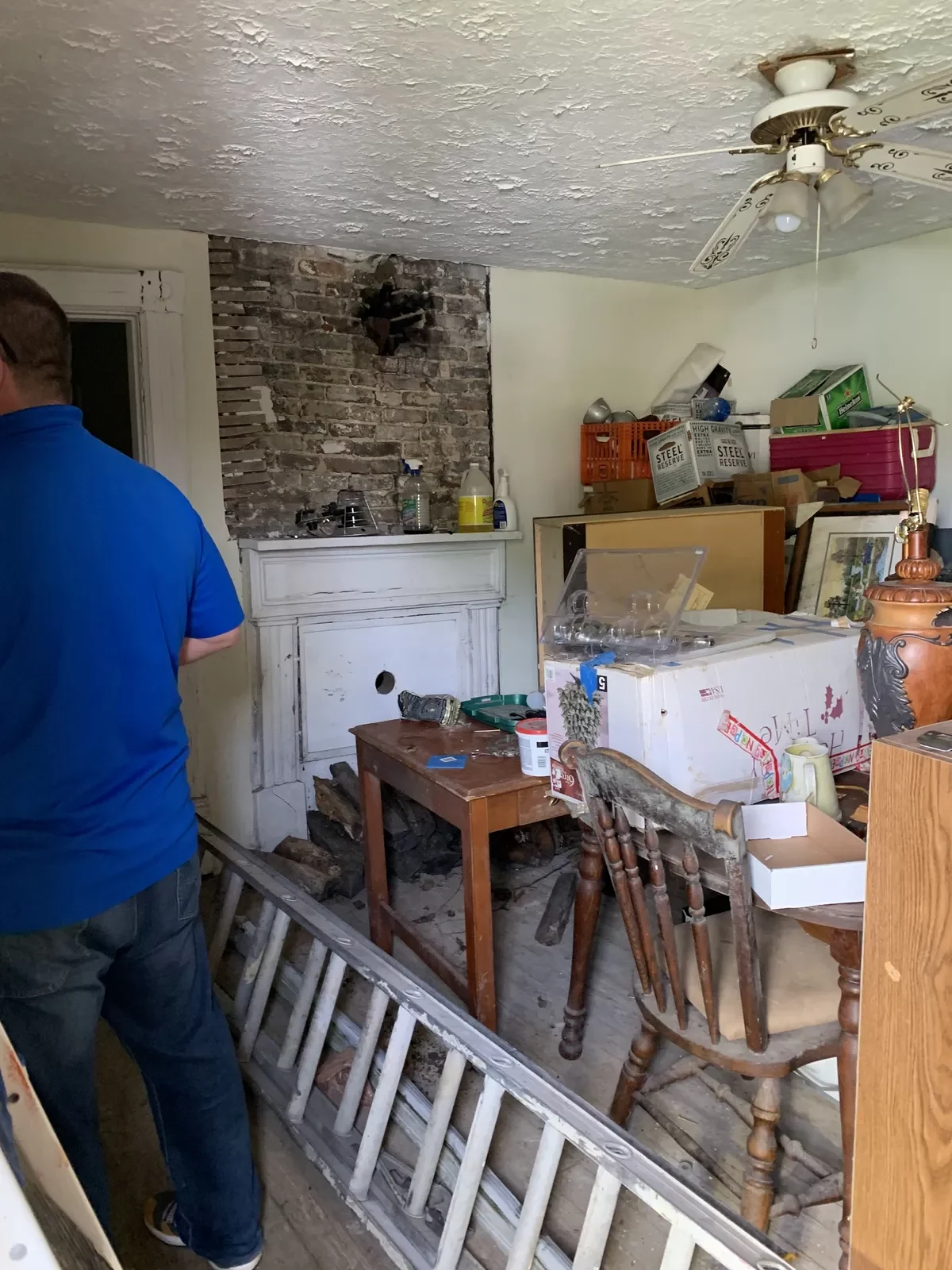 Before: Interior room packed with belongings in MLK Blvd home, Lexington KY