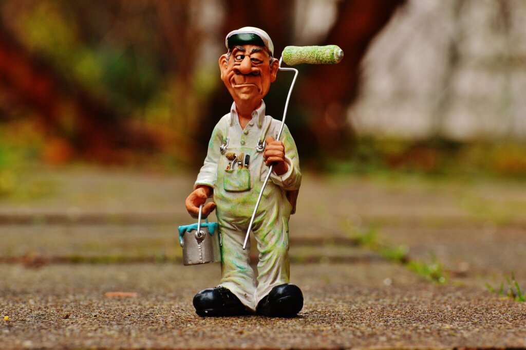 Man holding paint can and paint roller