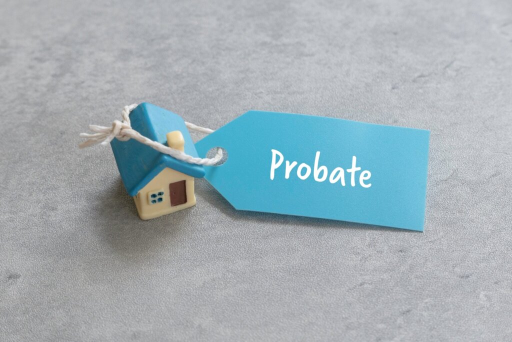 Austin probate house with estate documents, keys, and a sold sign representing an inherited property sale