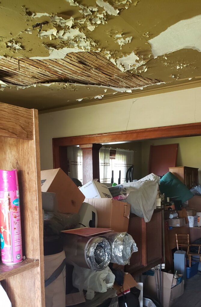 living room with junk piled up to ceiling that clear trail home buyers looked at in wausau wi