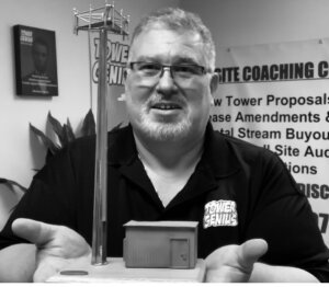 Picture of Cell Tower Help being offered by Steve from Tower Genius holding out a cell tower in his two hands. Cell tower lease experts.