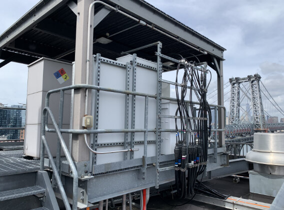 Brooklyn New York cell site with raised platform and cell site equipment cabinets cables.