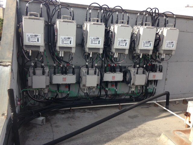 Cell site RRH RRU (remote radio head / remote radio unit) units on rooftop.