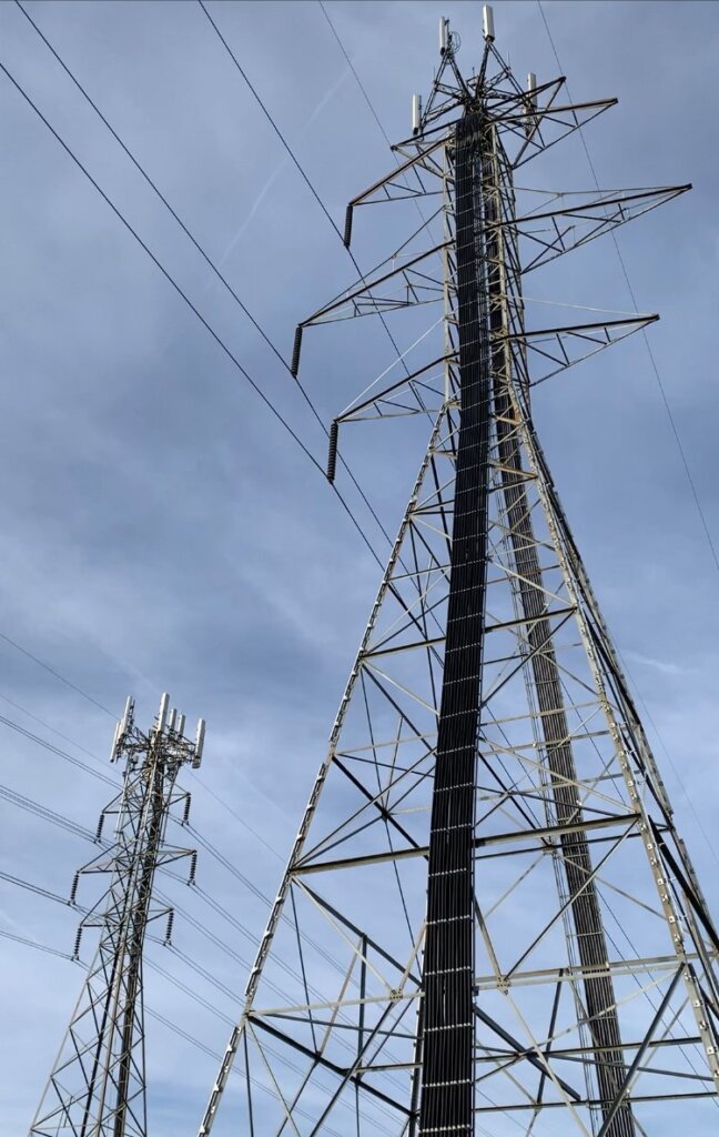 Electrical transmissions towers being utilized as cell towers.
