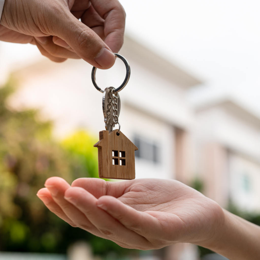 person handing over keys