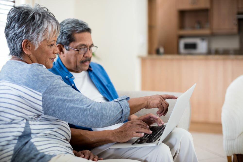 couple searching on laptop