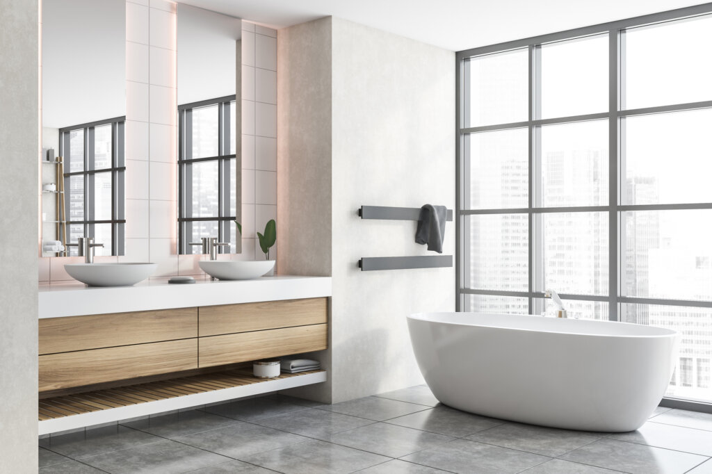 A modern bathroom renovations in Winnipeg with large windows and a bathtub