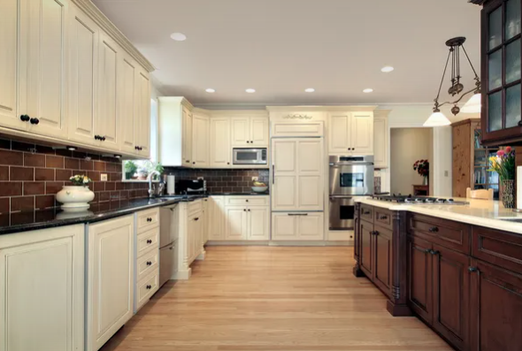 Kitchen renovations in Winnipeg with brown cabinets and black counter tops microwave