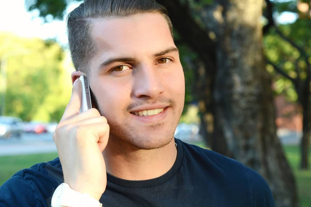 We buy houses honestly manager talking  on the 
 phone

