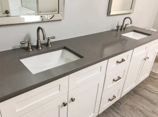 bathroom with granite and white cabinets plus sinks