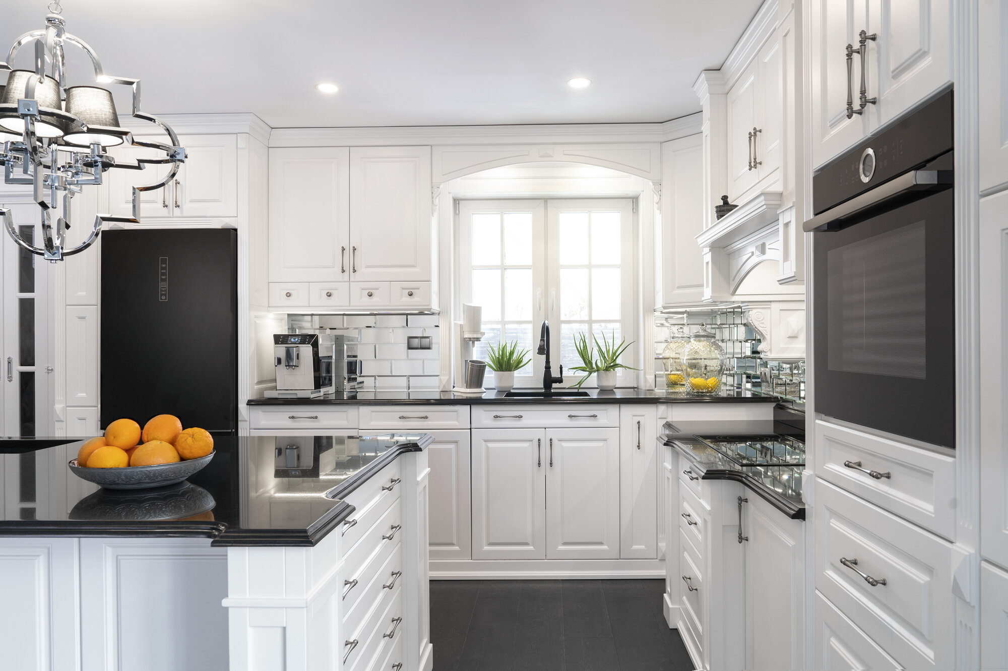 kitchen renovation  Winnipeg with white cabinets and black countertops 