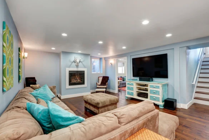 Winnipeg basement renovations living room with a fireplace, couches, and television