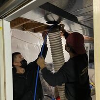 a group of men working on a vent cleaning Calgary