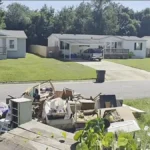 Belongings and debris outside a Pensacola rental house after the tenants were evicted