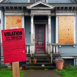 Tacoma home with a warning notice posted on the door for code enforcement