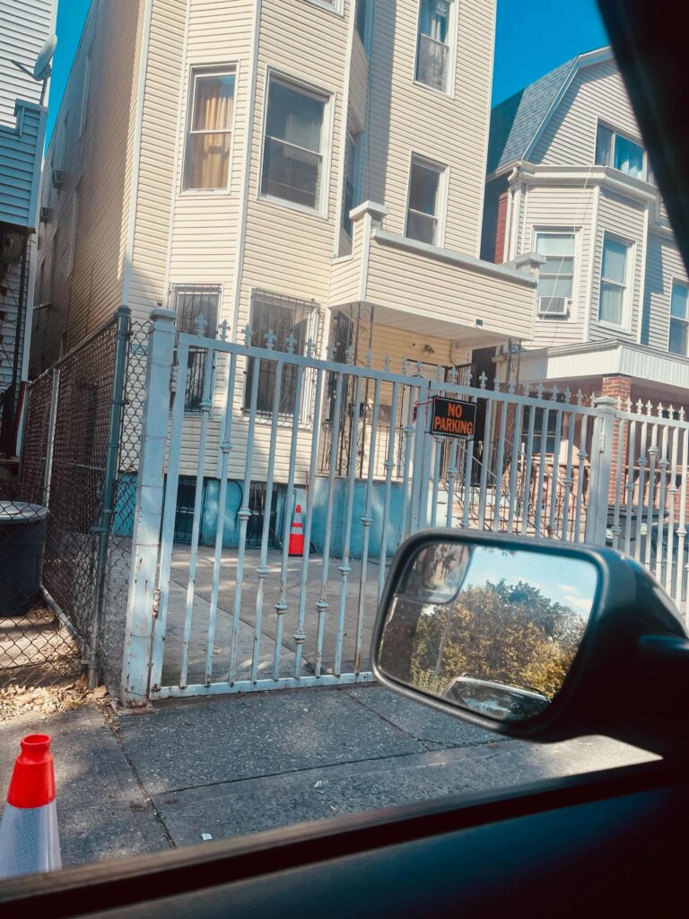 Multi-family house with white security gate and No Parking sign in Norwood Bronx NY near Montefiore Medical Center