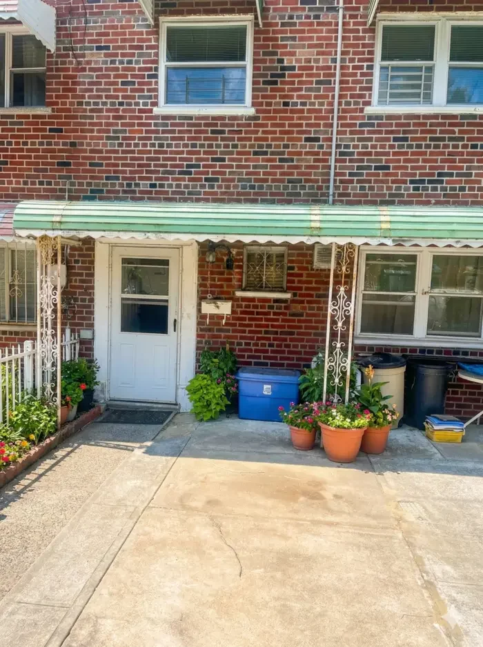 Brick two-family house with front driveway in Castle Hill, Bronx — typical home we buy for cash in any condition.