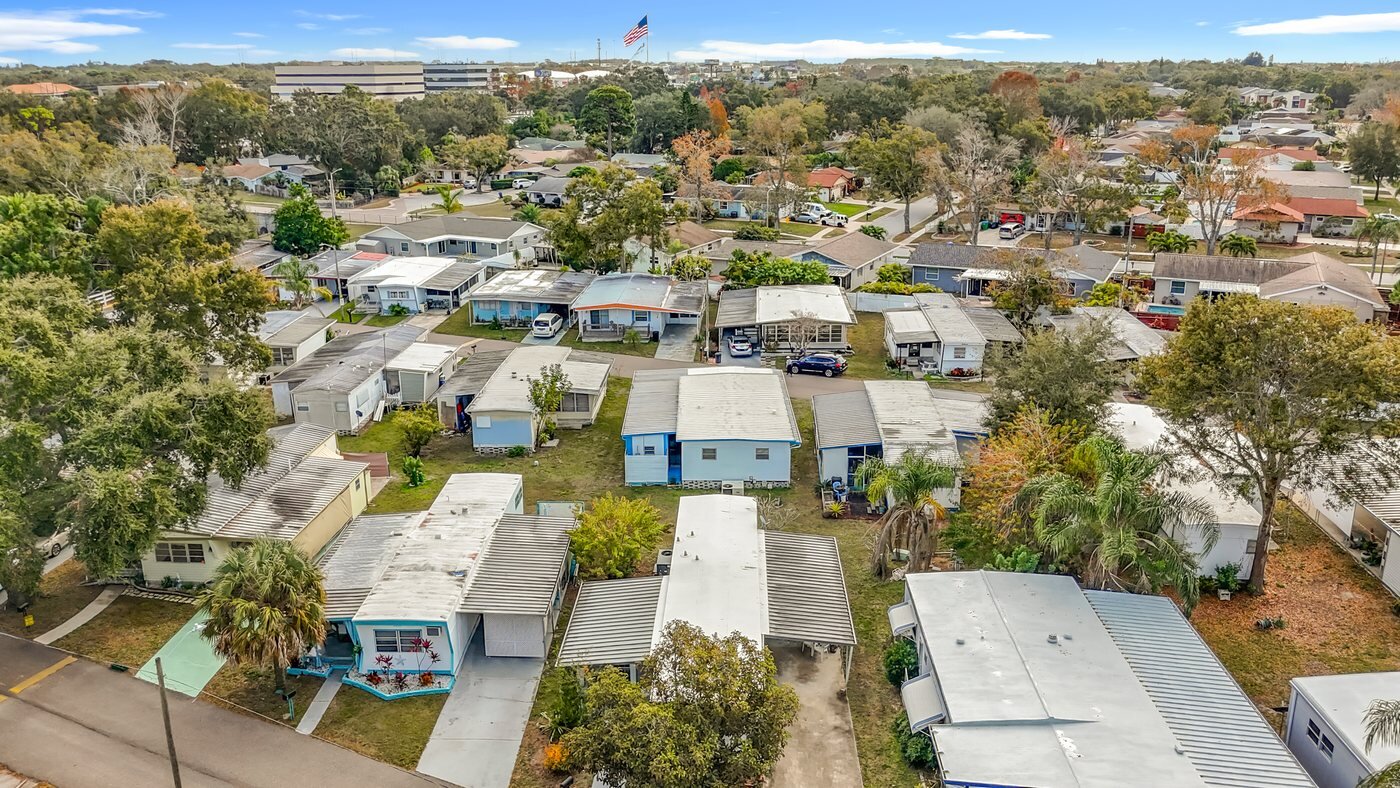Aerial view of a mobile home community in Clearwater, Florida, with rows of homes and mature landscaping
