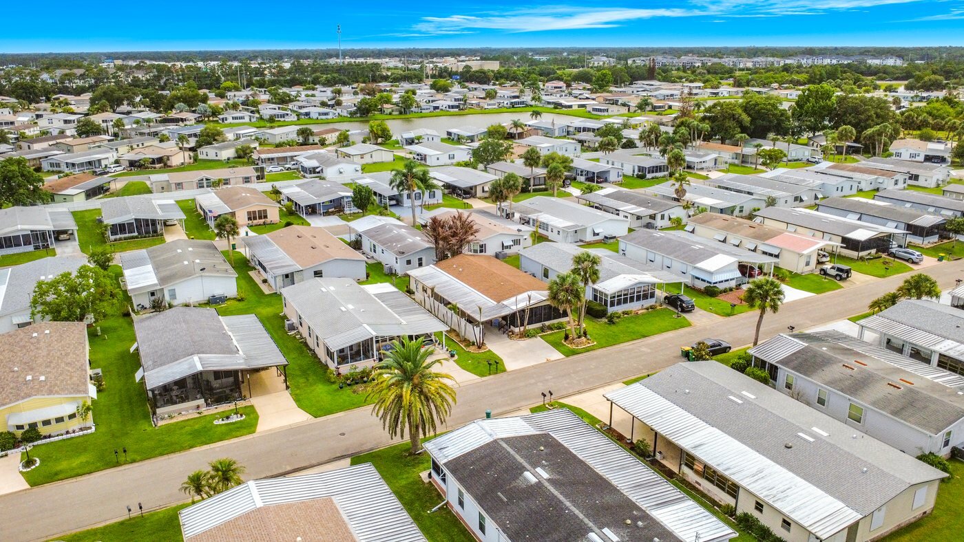 A mobile home listed by Florida Mobile Home Solutions in Melbourne, Florida, in an established community with mature landscaping