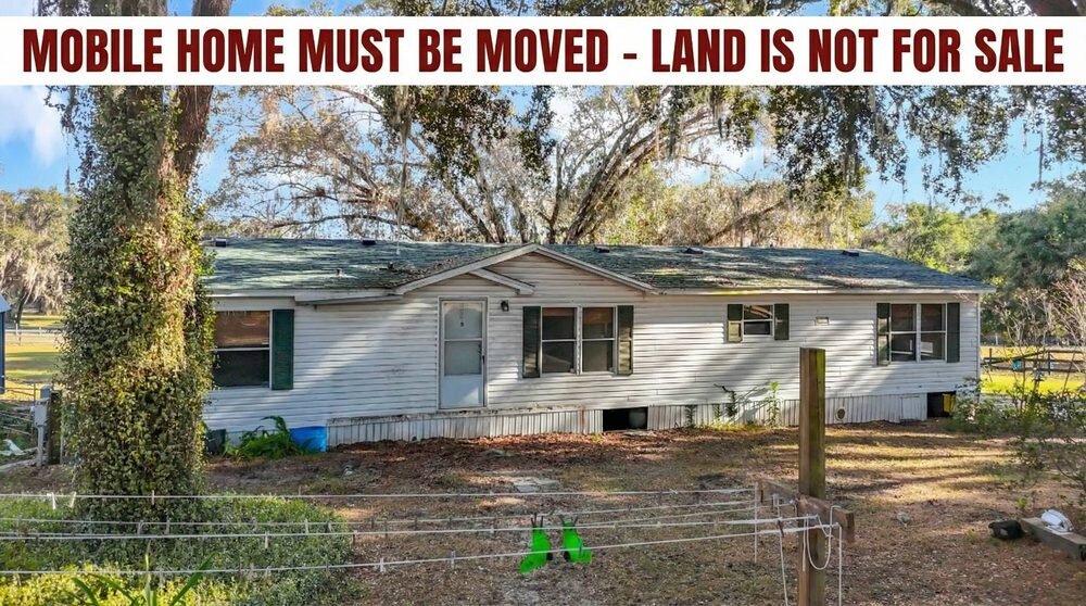 Older mobile home needing work, listed as must be moved with the land not for sale