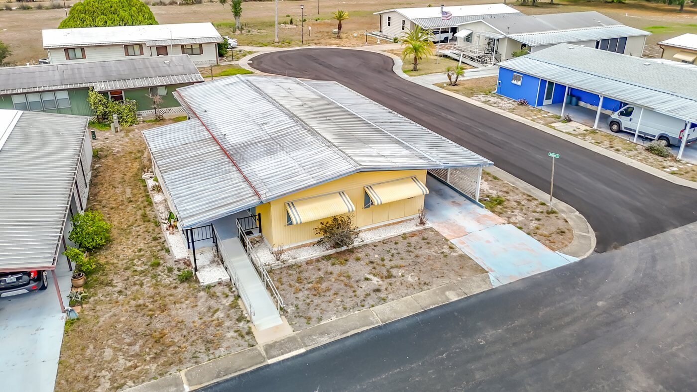 Aerial view of a mobile home community in New Port Richey, Florida, with paved streets and carports