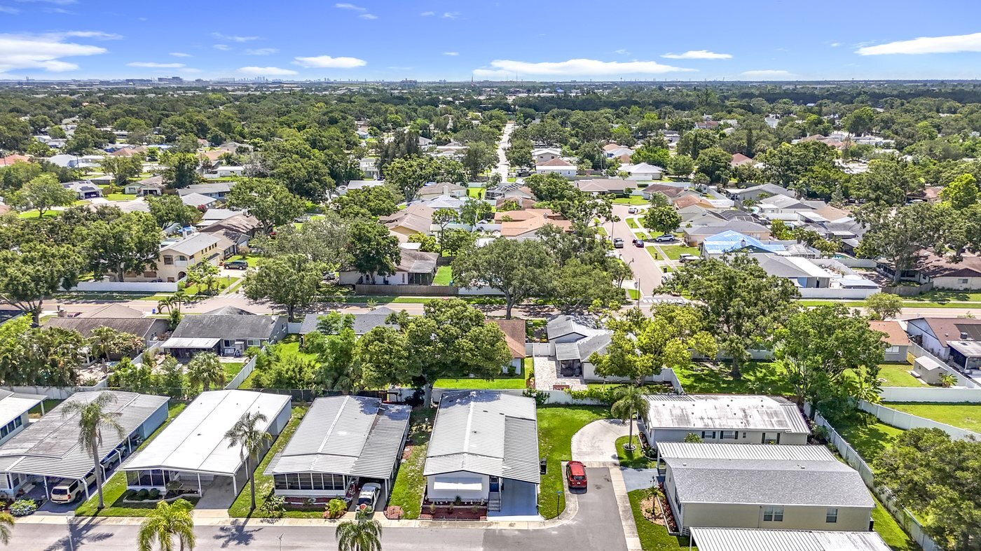 Aerial view of a mobile home community in Pinellas Park, Florida, with rows of homes and mature trees
