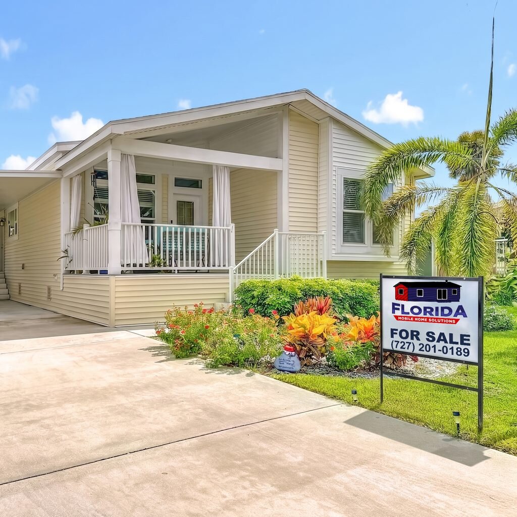 Florida mobile home listed for sale with a Florida Mobile Home Solutions sign in the front yard