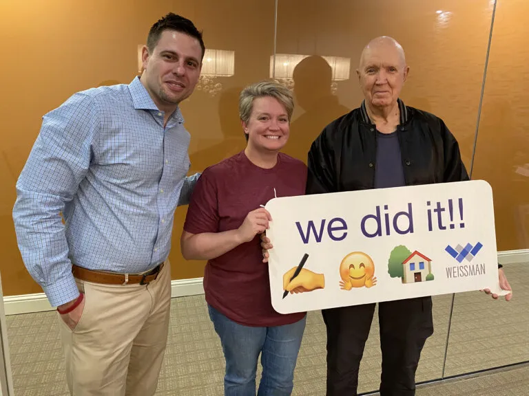 Coe Cameron with homeowners after helping them buy and sell a home