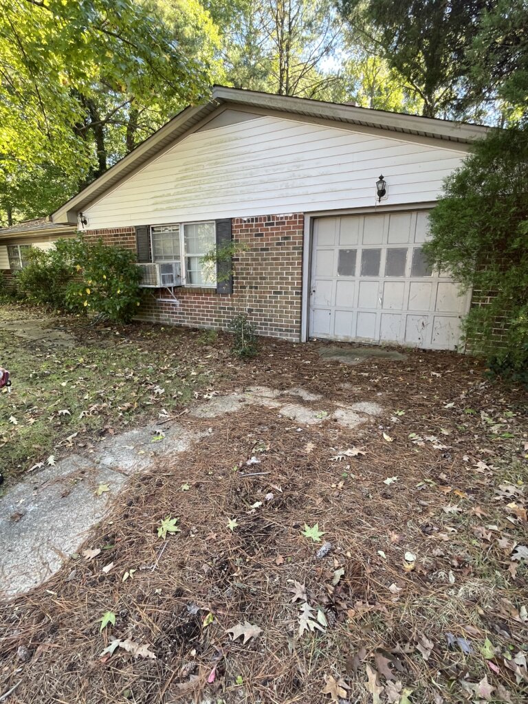 A exterior view house in Franklin Virginia with unattended backyard.