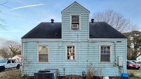 A picture of a Virginia home, with non-maintained grass, inherited by our client which he wanted to sell by one of our clients.