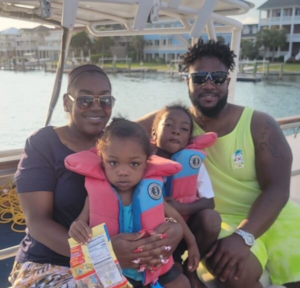 Monet Belton with her husband, Clarence, and their two children.